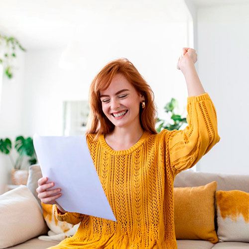 Chica contenta sujetando su factura de la luz